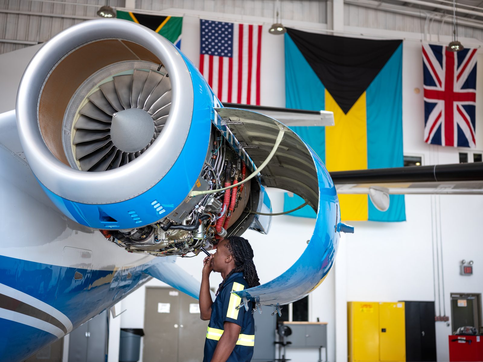TIA engineer inspecting a jet engine in the hangar