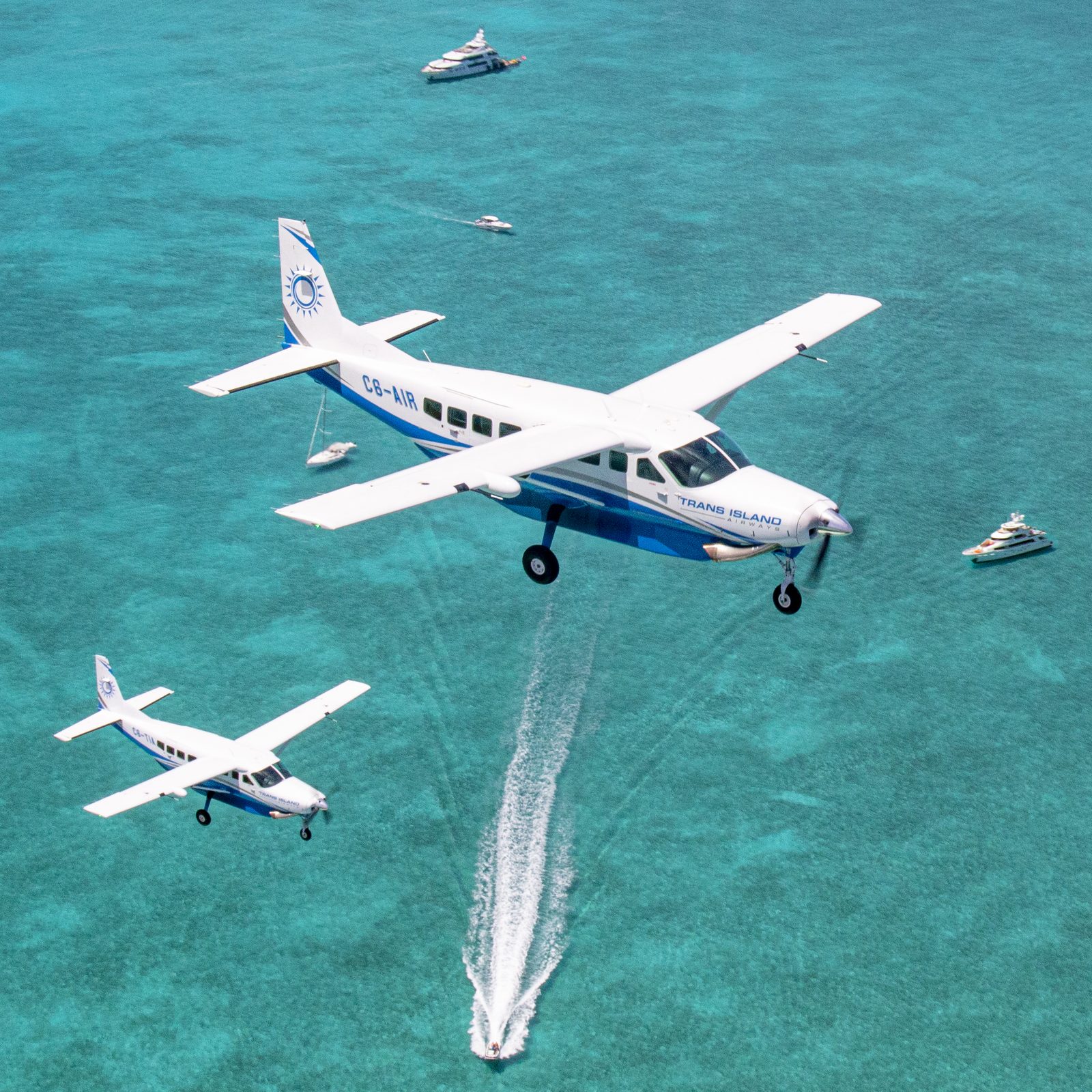 TIA Cessna Caravans flying low over turquoise Bahamian waters