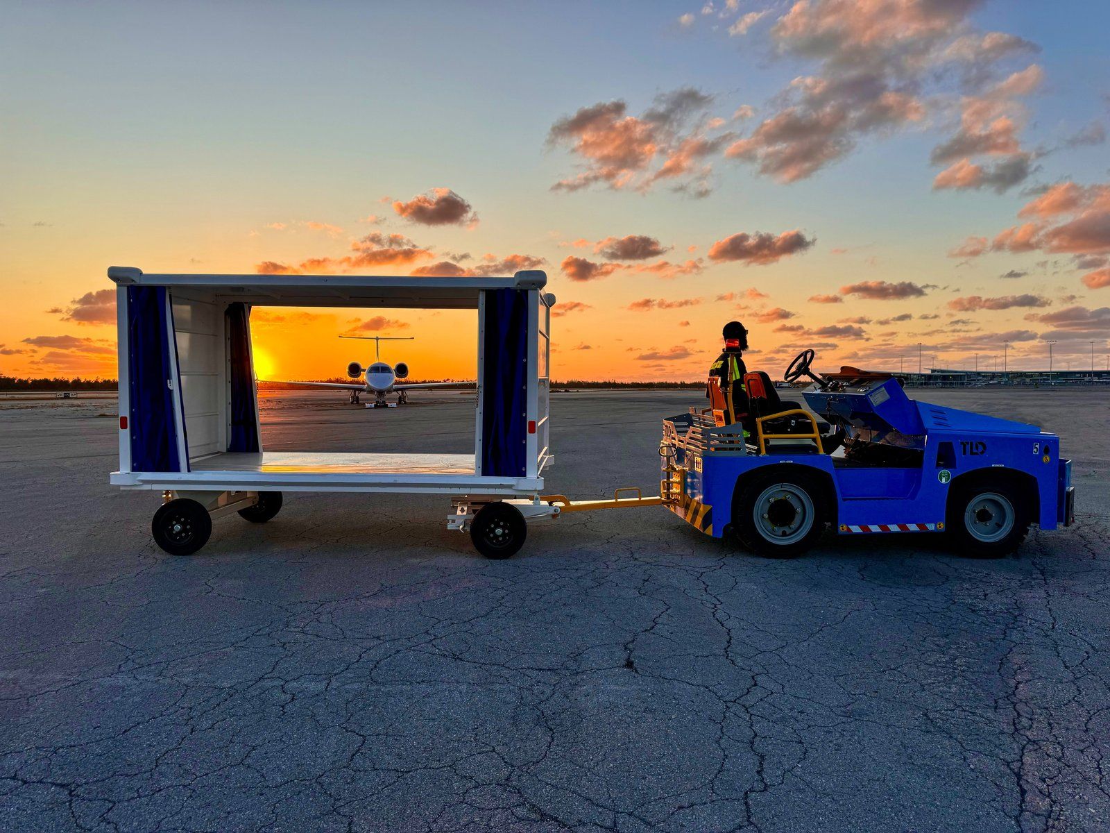 Trans Island Airways Embraer Legacy 600 with ground transport at sunset