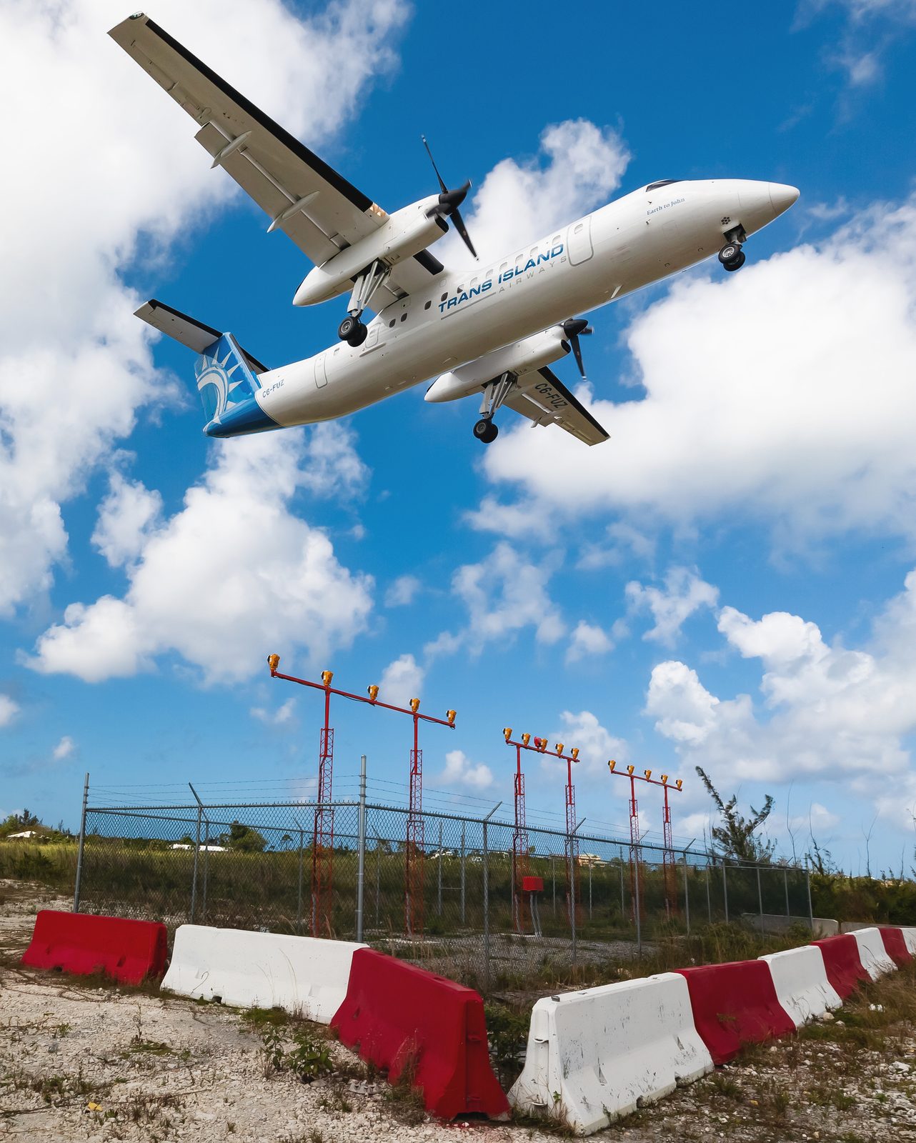 Trans Island Airways Dash 8 on short final over approach lights